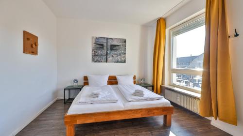 a small bedroom with a bed and a window at Spacious Flat 2nd Floor near station in Karlsruhe