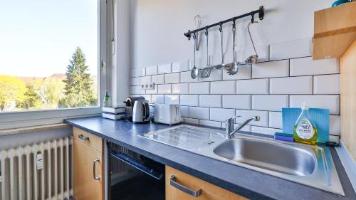 a kitchen counter with a sink and a window at Spacious Flat 2nd Floor near station in Karlsruhe