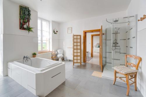 a white bathroom with a sink and a shower at Secret de Briques - classé 4 étoiles in Vigneux-Hocquet