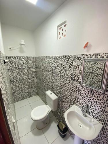 a bathroom with a toilet and a sink at Praia Jeri House in Jericoacoara