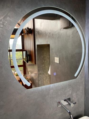 a mirror above a sink in a bathroom at Mount Lux Villa in Devāla