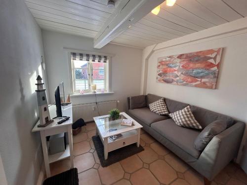 a living room with a couch and a table at Lykke in Wrixum