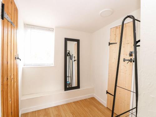 a bathroom with a mirror and a window at Vintner's Cottage in Norwich