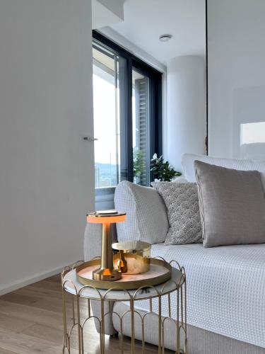 a living room with a couch and a table at DeLux Apartment Koper - NEW in Koper