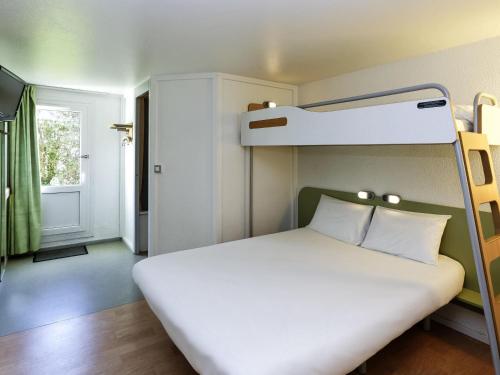 a bedroom with a bed with a bunk bed at Ibis budget Lorient Caudan in Caudan