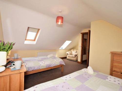 a bedroom with two beds and a couch at 2 Bed in Mold oc-41656 in Caerwys