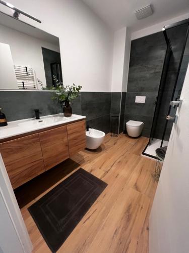 a bathroom with two toilets and a sink and a shower at Mood Valentina in Goriano Sicoli
