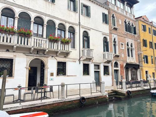 a group of buildings next to a canal with water at iH Hotels Venezia Salute Palace in Venice