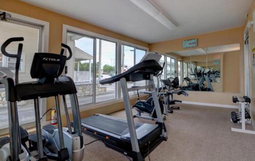 a gym with a row of tread machines in a room at Pier 7 Condominium Resort in Yarmouth