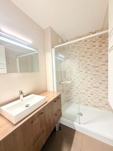 a white bathroom with a sink and a shower at M046 T3 cosy 2 chambres et balcon in Ambilly