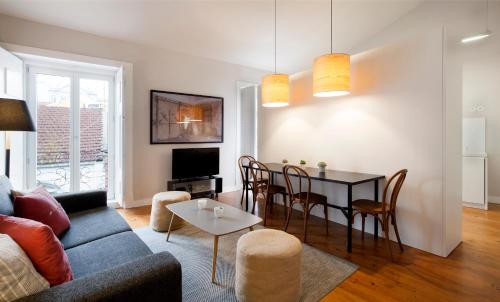 a living room with a couch and a table at Lisbon Five Stars Apartments Combro 7 in Lisbon