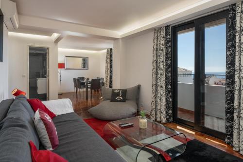 a living room with a couch and a glass table at Casa Sta Clara by An Island Apart in Funchal