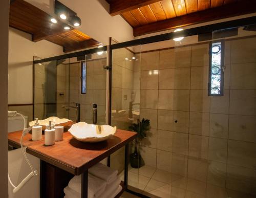 a bathroom with a sink and a shower at Finca La Marta - El Cortijo Wine Lodge in Capilla del Monte