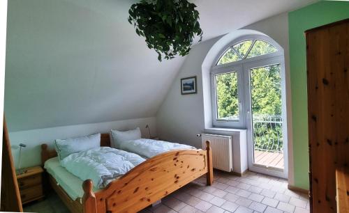 a bedroom with a bed in a room with a window at Villa Luba in Koserow