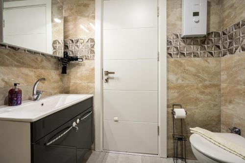 a bathroom with a sink and a toilet at ARCADIA Homes in Alanya