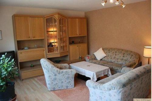 a living room with two couches and a table at Haus-Schneider-grosse-Ferienwohnung in Wolfshagen