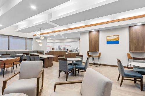 a waiting room with tables and chairs at Sonesta ES Suites Phoenix Goodyear in Goodyear