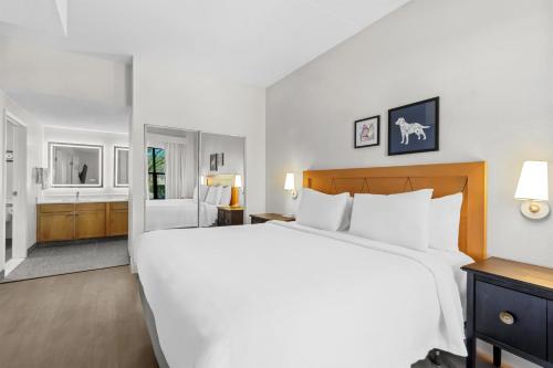 a large white bed in a hotel room at Sonesta ES Suites Phoenix Goodyear in Goodyear