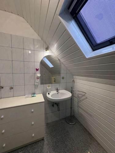 a bathroom with a sink and a mirror at Erika Vendégház in Igal