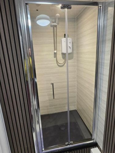 a shower with a glass door in a bathroom at Levy Nook 6 in Darlington