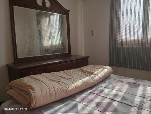 a bedroom with a bed with a dresser and a mirror at Royal Chalet Sea View - Stella Di Mare - Families in Az Zafarani