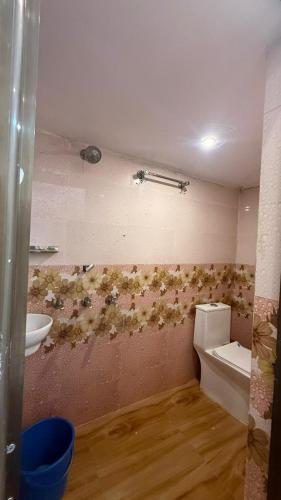 a bathroom with a toilet and a sink at Utkarsh Palace And Restaurant in Ayodhya Ghā