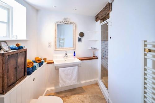 a bathroom with a sink and a shower at Finest Retreats - Mill Barn By The Stream in West Lydford