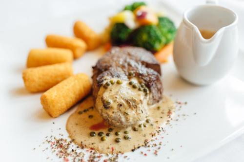 a plate of food with a piece of meat and vegetables at Gasthof Gierlinger in Obermühl