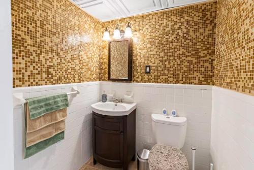 a bathroom with a toilet and a sink at Sun-Filled and Spacious One-Level Buckhead Oasis in Atlanta