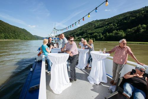a group of people on a boat on the water at Gasthof Gierlinger in Obermühl