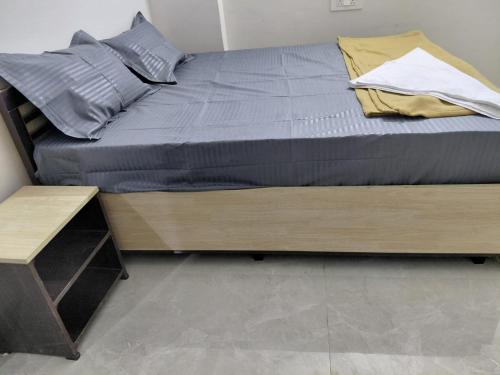 a bed with a wooden bed frame and a table at sea shore stays in Rushikonda