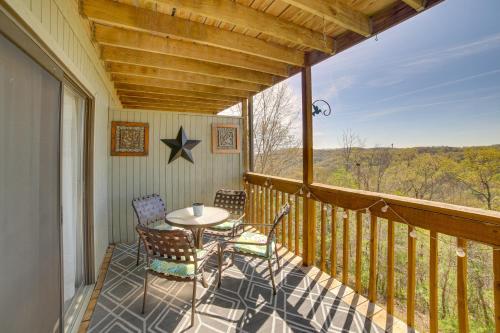 a porch with a table and chairs on a balcony at Unwind Fireside Ozark Mtn Condo with Resort Perks! in Branson
