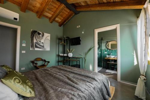 a bedroom with green walls and a large bed at Bed & Breakfast Gioia di... in Santo Stino di Livenza