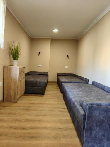 a room with two beds and a wooden floor at U Władzia in Gowidlino