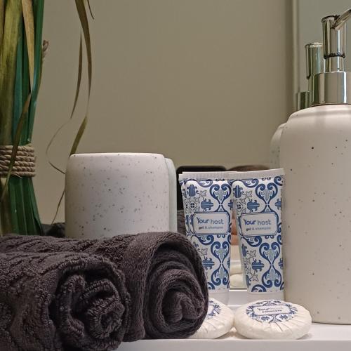 a bathroom with towels and candles on a counter at RestOnDouro Oporto Family in Valbom