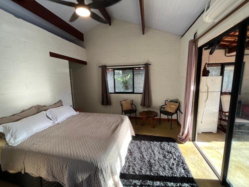 a bedroom with a bed and a table and chairs at Chalé Mon Amour com sua piscina privativa in São Miguel do Gostoso