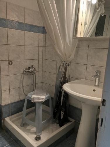 a bathroom with a sink and a stool next to a sink at IZEΛA Hotel in Kala Nera