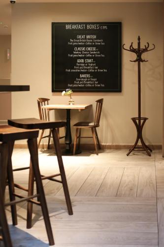 a classroom with a table and chairs and a chalkboard at hub London - Spitalfields in London