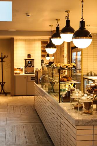 a bakery with a counter with food on it at hub London - Spitalfields in London