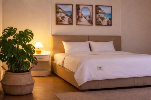 a bedroom with a bed and a potted plant at Homemie in Binh Hai