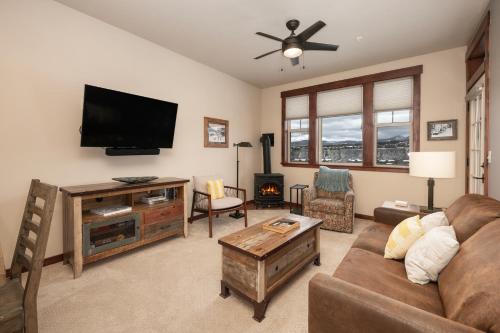 a living room with a couch and a flat screen tv at Cozens Pointe Building G Unit 202 in Fraser
