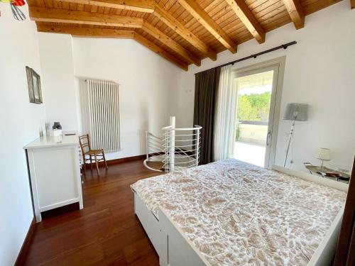 a bedroom with a bed and a large window at Villa Gardoncino in Manerba del Garda