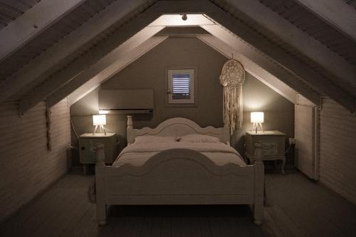 a bedroom with a large bed and two night stands at Nectar Cottages in Varákkes