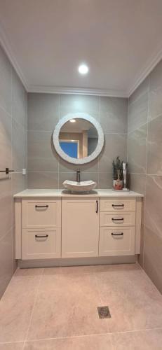 a bathroom with a sink and a mirror at Coastal Calm Seascapes unit 2 in Falcon