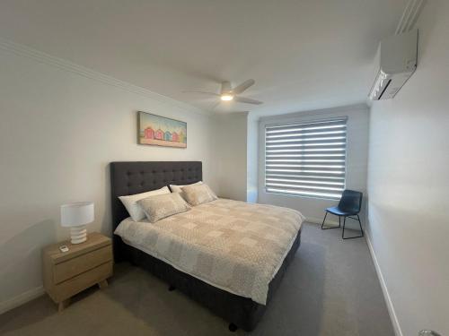 a bedroom with a bed and a ceiling fan at Coastal Calm Seascapes unit 2 in Falcon