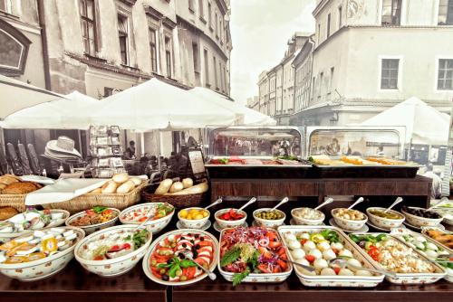 a buffet of food on a table in a city at Hotel Victoria in Lublin