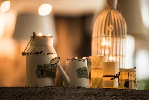 two tea cups with candles and a bird cage at Hotel Victoria in Lublin