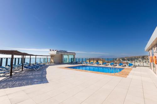a view of the pool at a resort with chairs at BLUESEA Calabahía in Cala del Moral