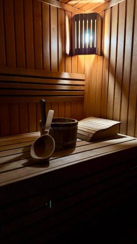 a wooden sauna with a bowl and a utensil in it at Відпочинковий - комплекс '"Замок Лева"" in Peremyshlyany
