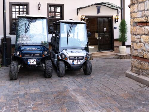 two golf carts parked in front of a house at Morea Kaleiçi-Adults Only in Antalya